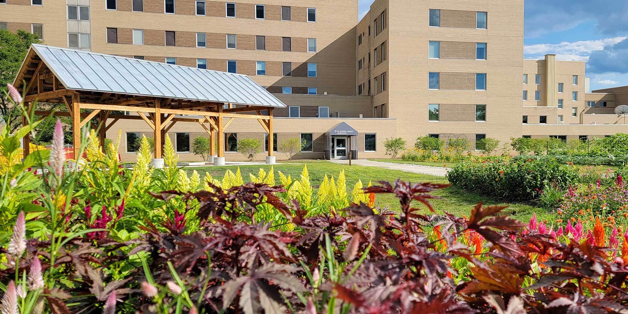 A flower garden outside of a Trinity Health Michigan hospital