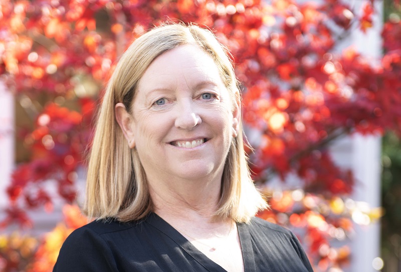 Melinda smiling outside.