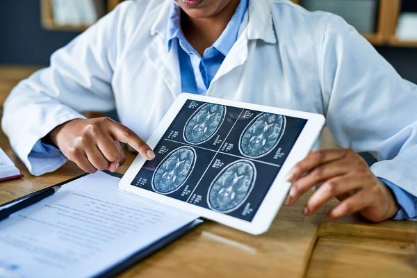 doctor showing patient brain scans