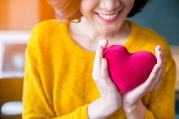 woman holding heart shape
