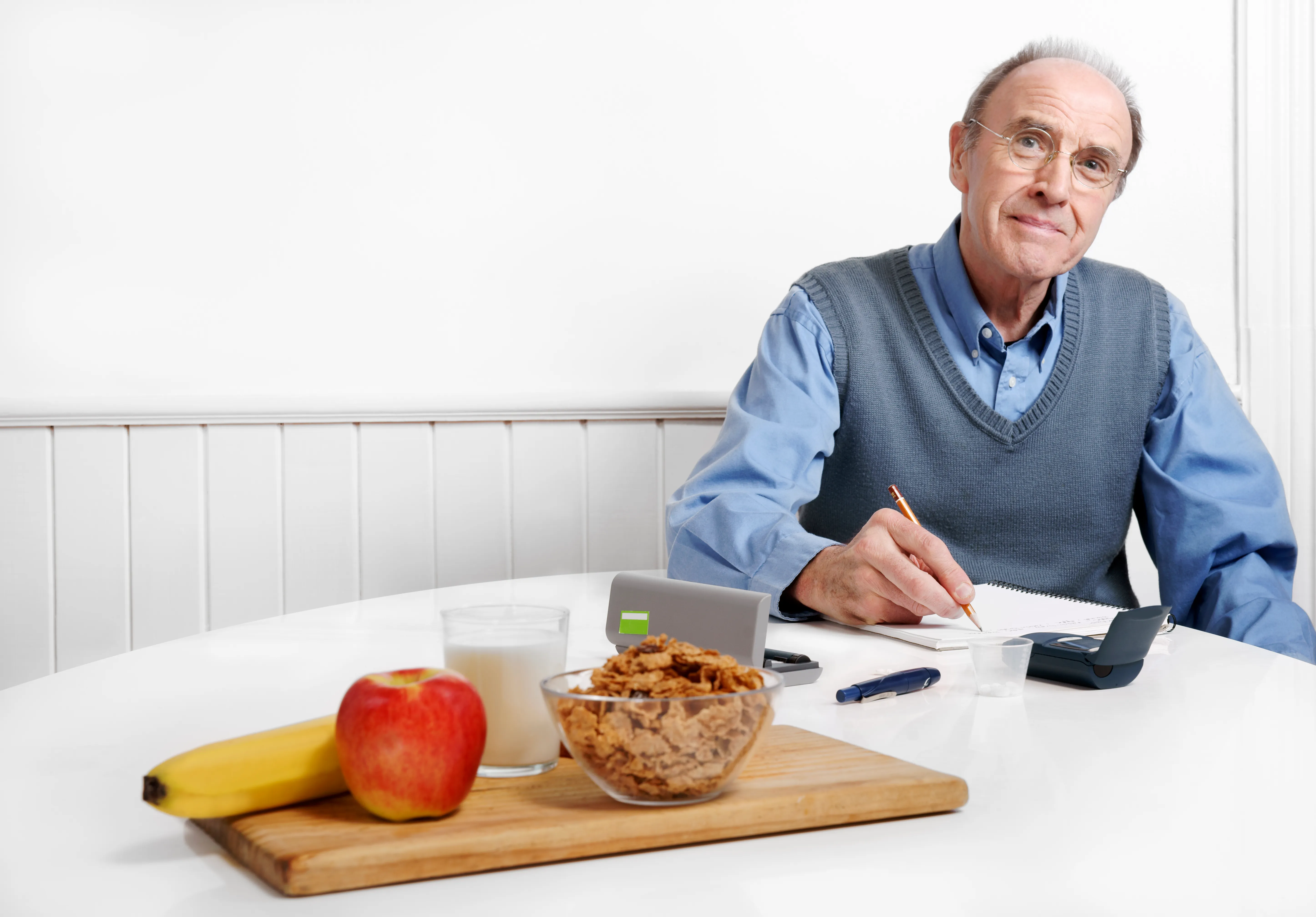 Diabetic Man Recording His Blood Sugar Level Or Calorie Count