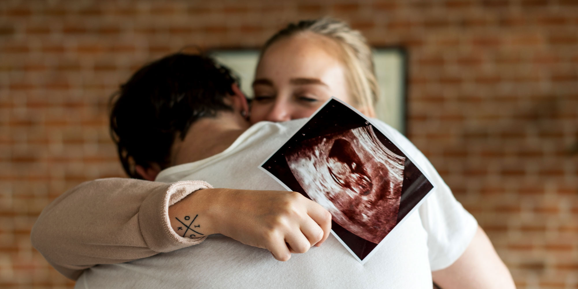 couple hugging with ultrasound