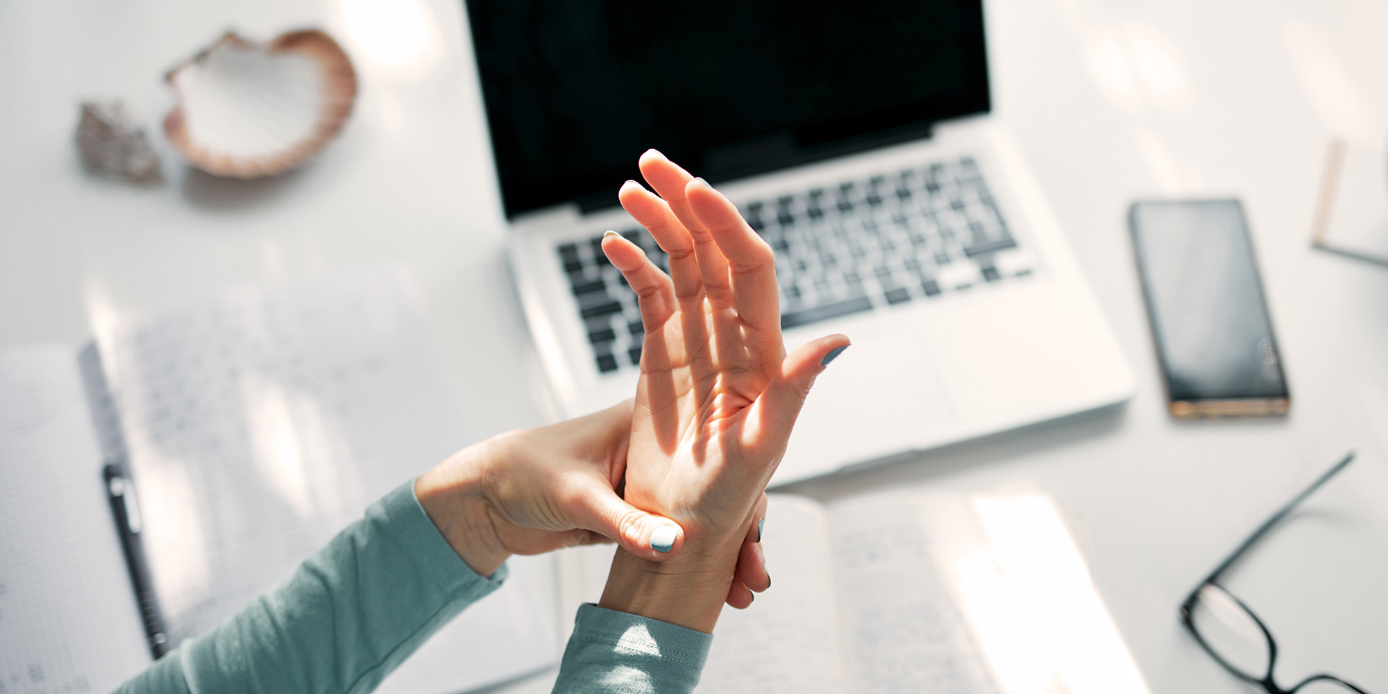 womans hand using computer
