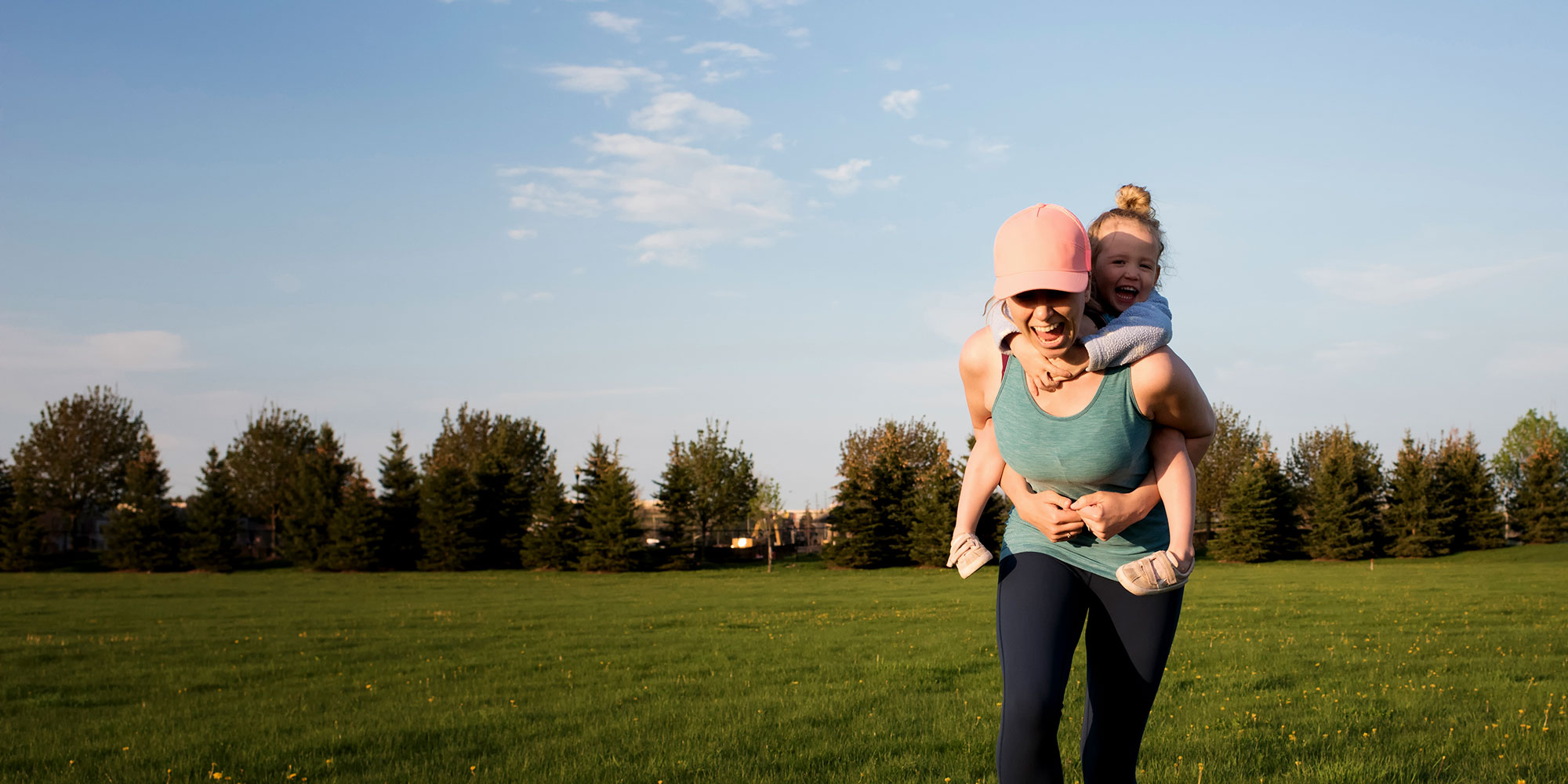 Mother walking carrying her child on her back